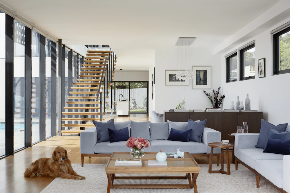 Living room with a soft area rug and a staircase